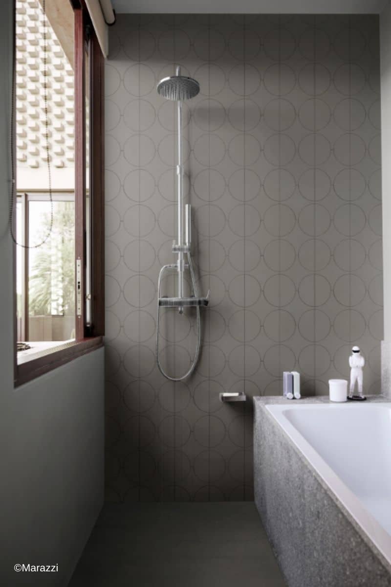marazzi-cementum-schlauchbad Enges, schlauchförmiges Bad mit schmaler Badewanne und Dusche am Raumende, gefliest mit den Fliesen der Kollektion Cementum von Marazzi